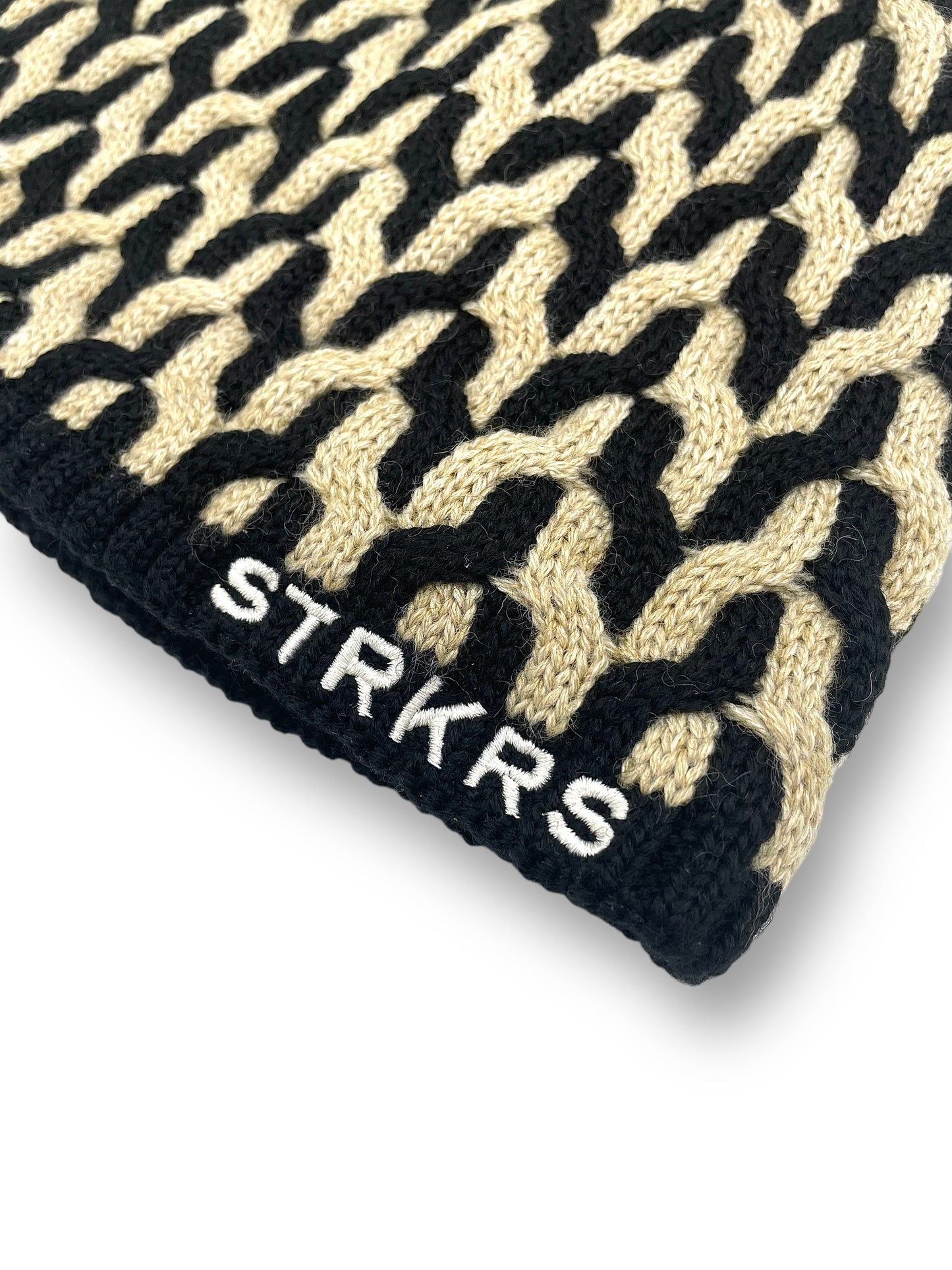 STRKRS black and white mens women's unisex soft warm insulating wool acrylic blend uniquely patterned low profile skullcap beanie with brim. Line with a cozy polyester fleece interior. STRKRS Logo embroidered on ribbed brim.