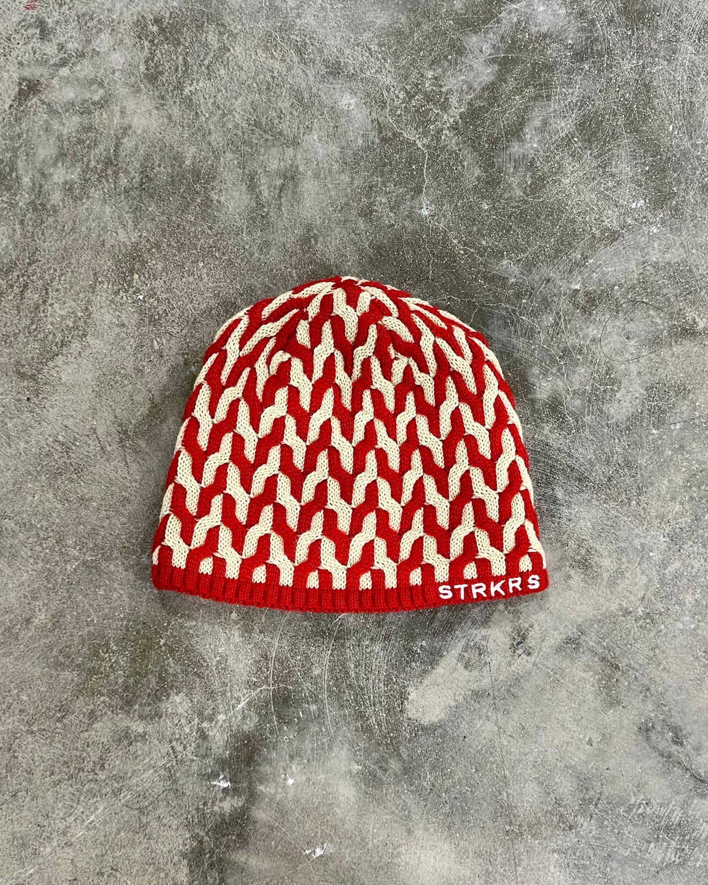 STRKRS red and white mens women's unisex soft warm insulating wool acrylic blend uniquely patterned low profile skullcap beanie with brim. Line with a cozy polyester fleece interior. STRKRS Logo embroidered on ribbed brim.