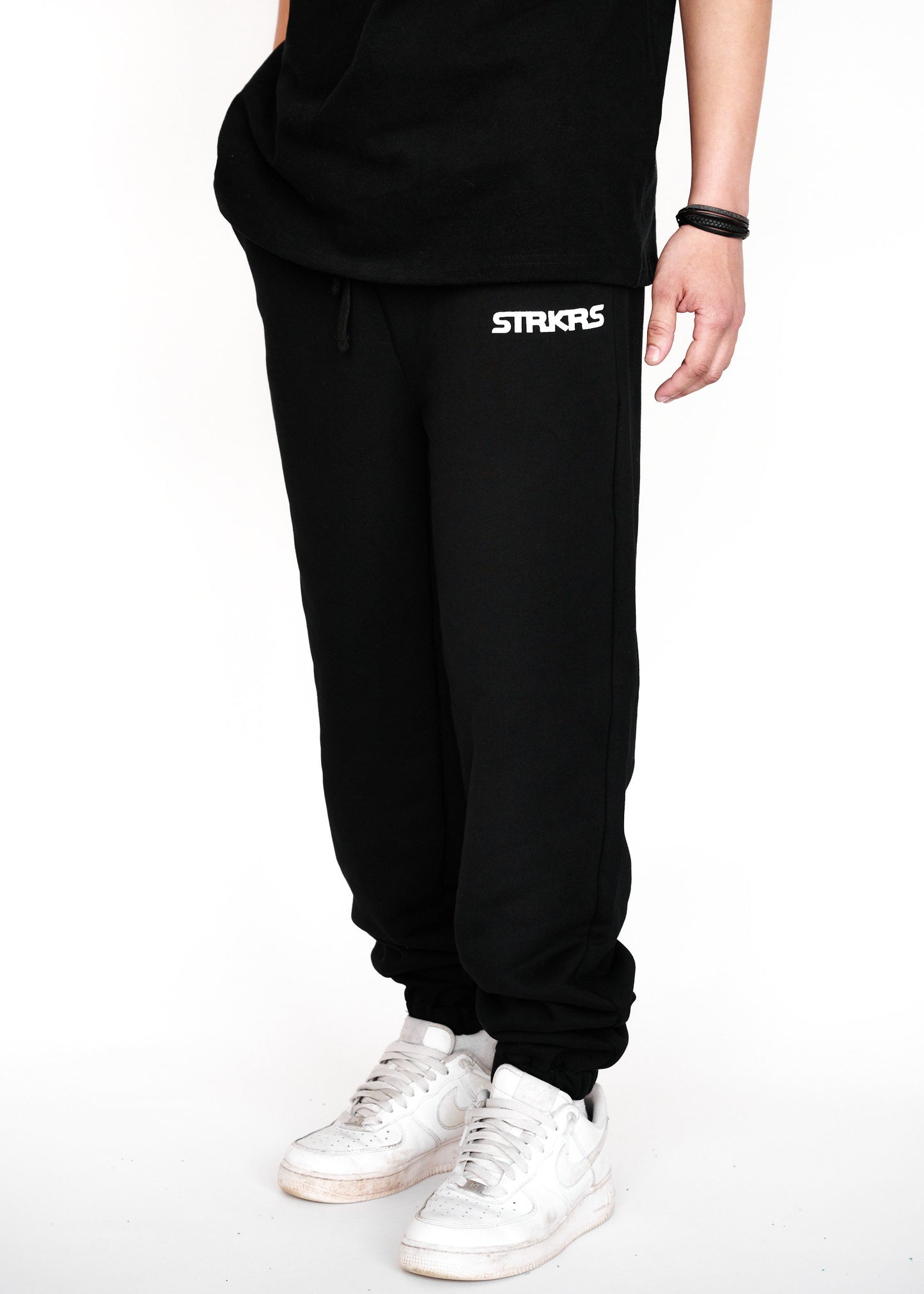 STRKRS black and white mens women's unisex 100% French Terry cotton heavyweight relaxed slightly baggy sweatpants. STRKRS Core Logo screen printed at center chest.