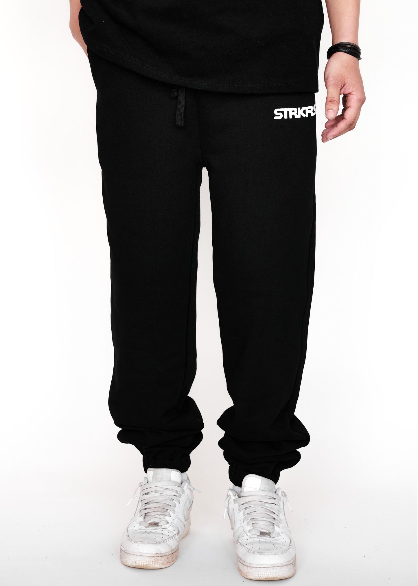STRKRS black and white mens women's unisex 100% French Terry cotton heavyweight relaxed slightly baggy sweatpants. STRKRS Core Logo screen printed at center chest.