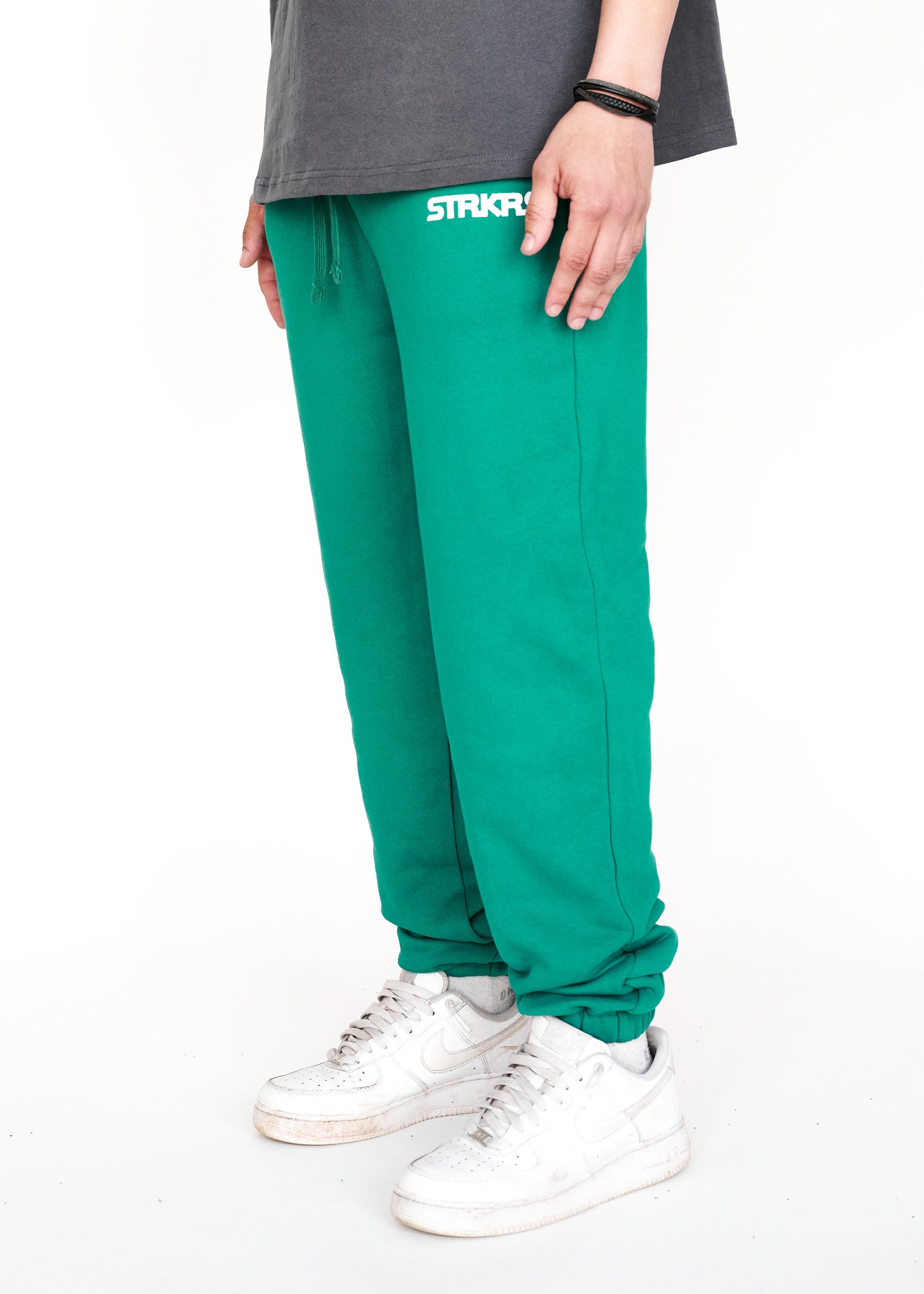 STRKRS cadmium green mens women's unisex 100% French Terry cotton heavyweight relaxed slightly baggy sweatpants. STRKRS Core Logo screen printed at center chest.