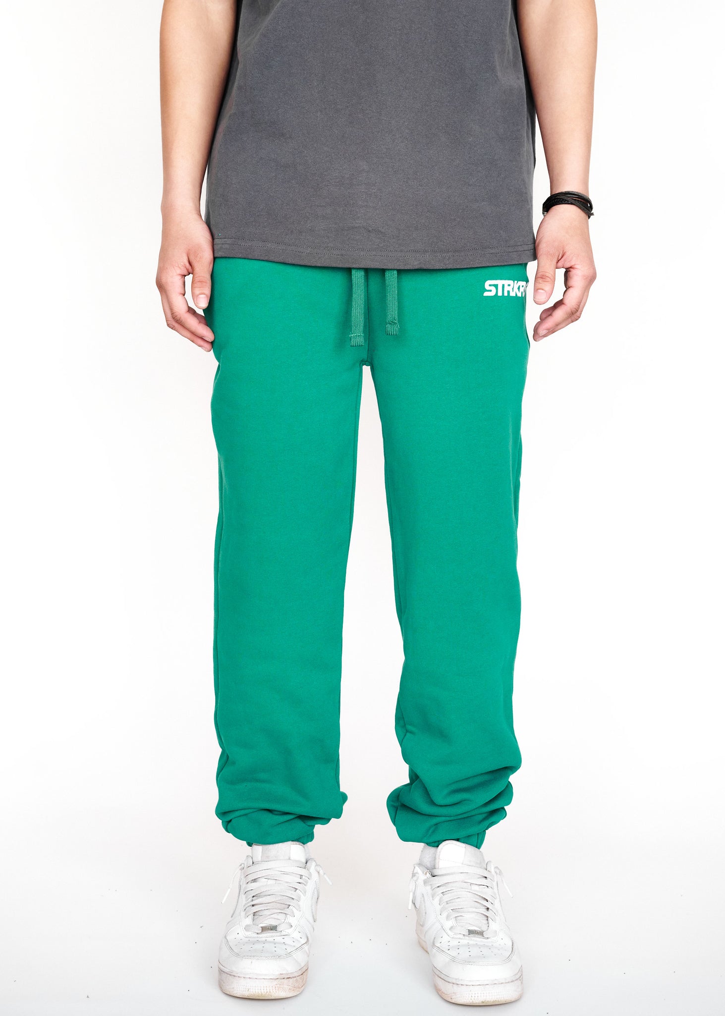 STRKRS cadmium green mens women's unisex 100% French Terry cotton heavyweight relaxed slightly baggy sweatpants. STRKRS Core Logo screen printed at center chest.