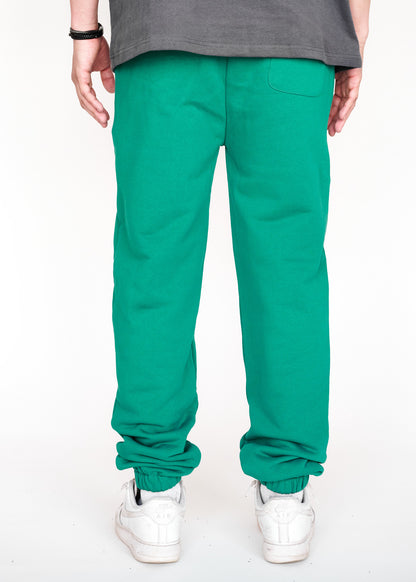 STRKRS cadmium green mens women's unisex 100% French Terry cotton heavyweight relaxed slightly baggy sweatpants. STRKRS Core Logo screen printed at center chest.