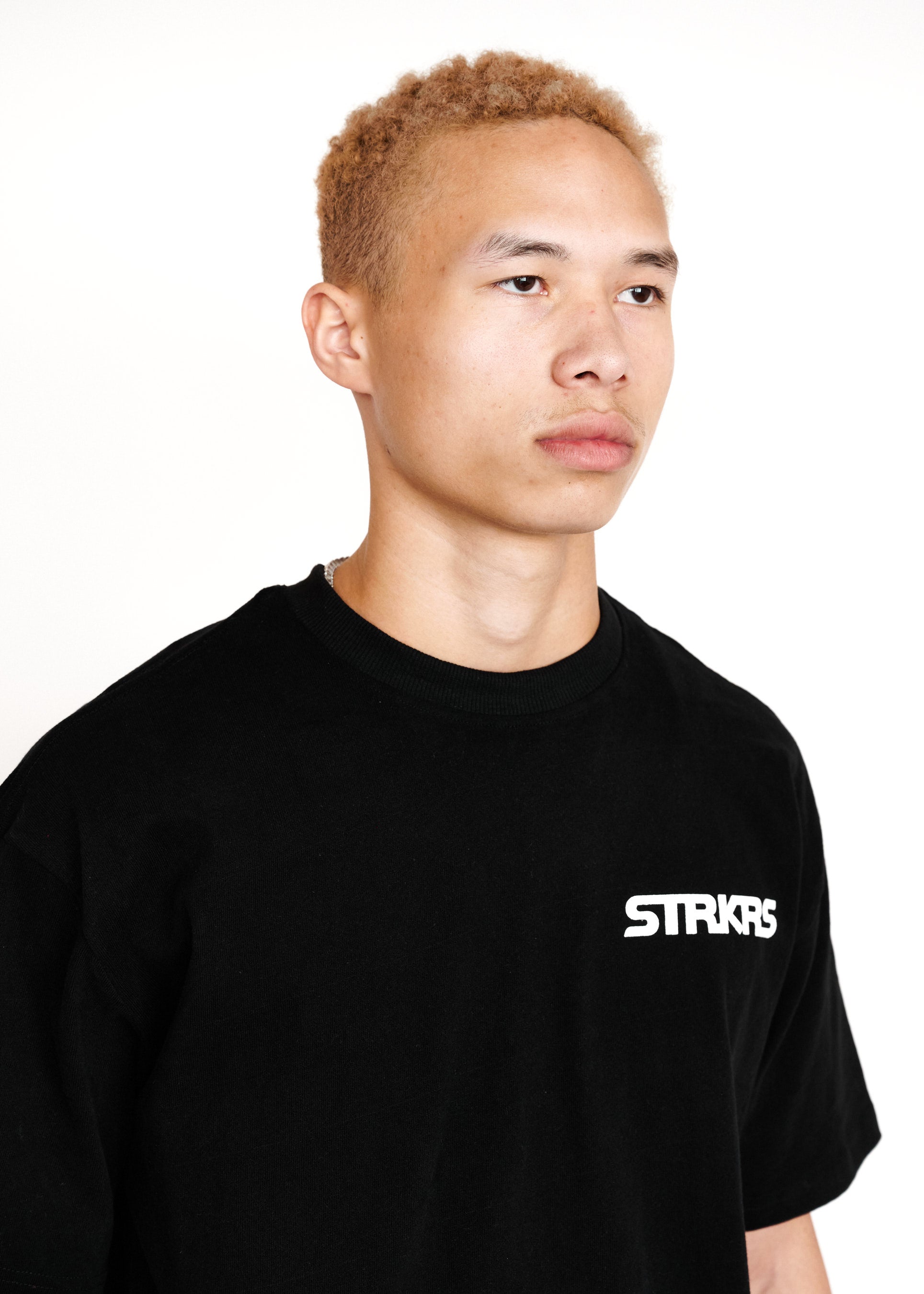 STRKRS black and white mens women's unisex 100% cotton heavyweight crewneck relaxed slightly oversized t-shirt. Single-minded Driven Purposeful on back of t-shirt
