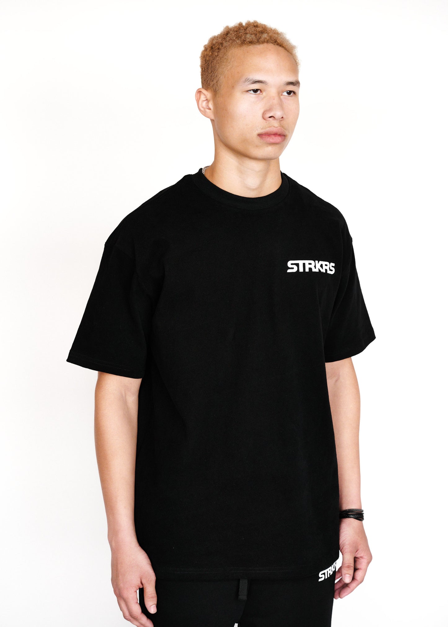 STRKRS black and white mens women's unisex 100% cotton heavyweight crewneck relaxed slightly oversized t-shirt. Single-minded Driven Purposeful on back of t-shirt
