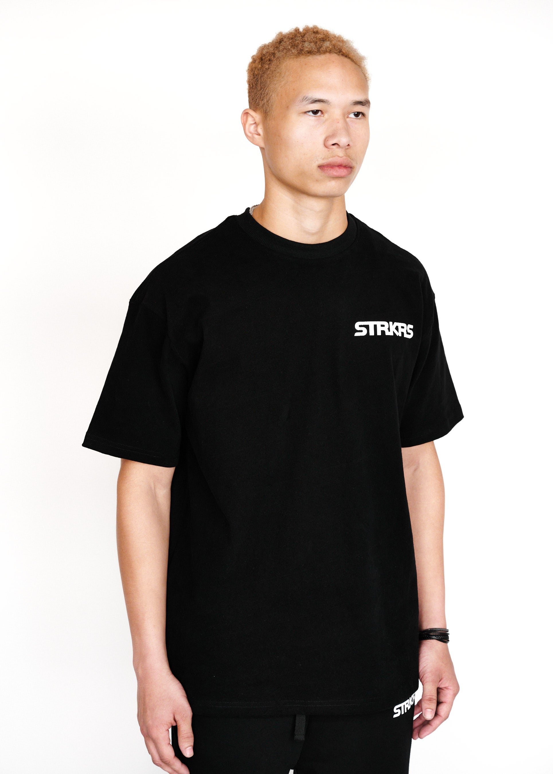 STRKRS black and white mens women's unisex 100% cotton heavyweight crewneck relaxed slightly oversized t-shirt. Single-minded Driven Purposeful on back of t-shirt