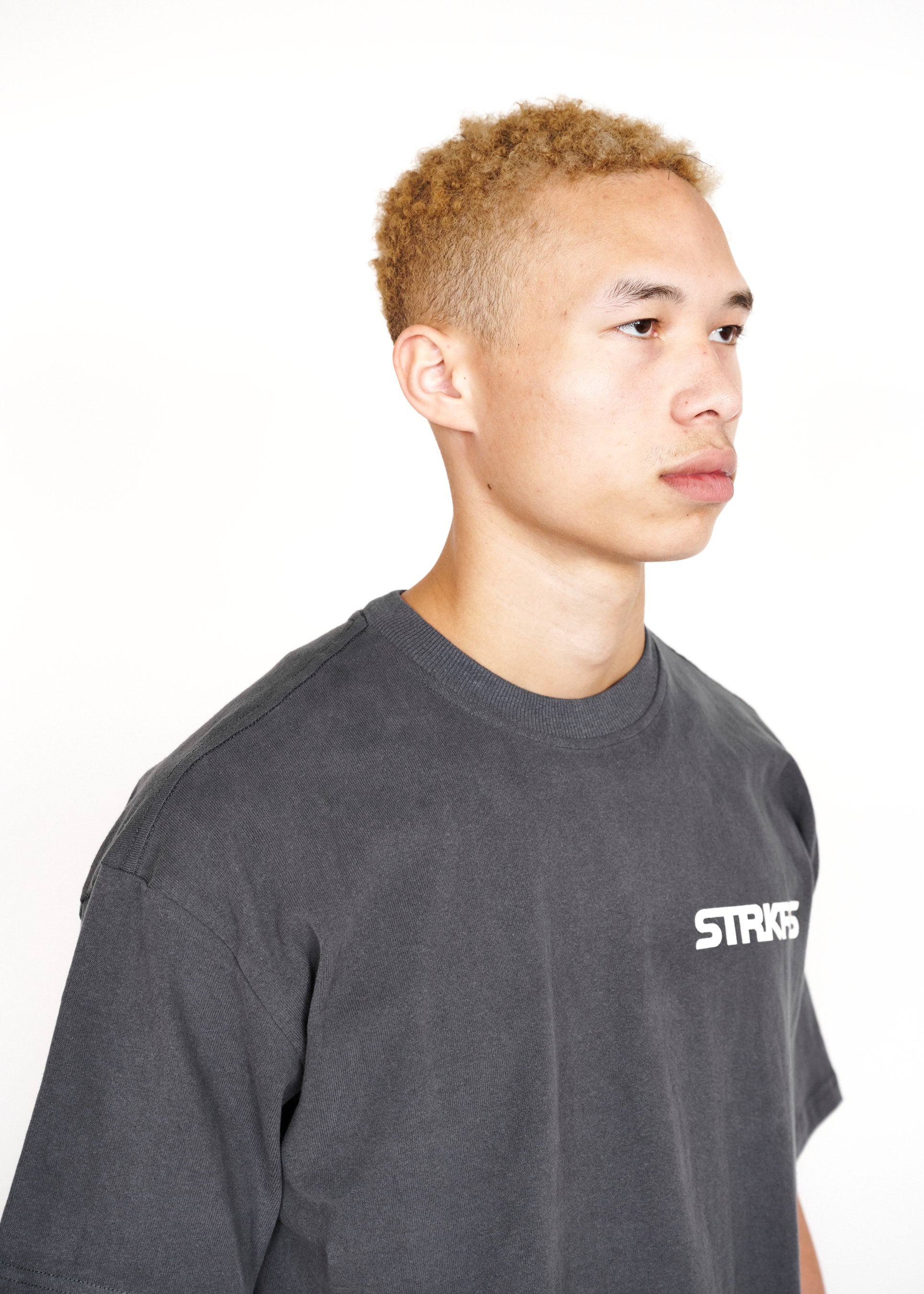 STRKRS washed gray and white mens women's unisex 100% cotton heavyweight crewneck relaxed slightly oversized t-shirt. Single-minded Driven Purposeful on back of t-shirt